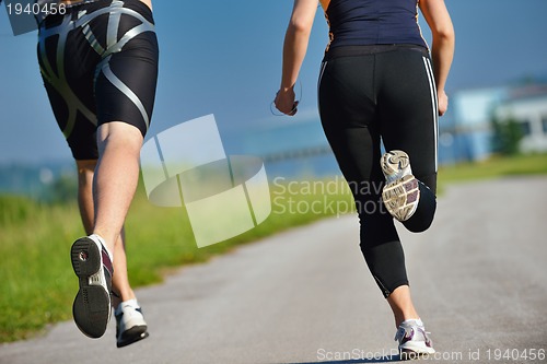 Image of Young couple jogging at morning