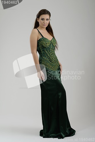 Image of elegant woman in fashionable dress posing in the studio