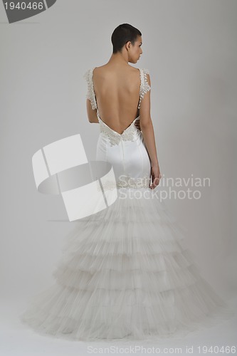 Image of elegant woman in fashionable dress posing in the studio