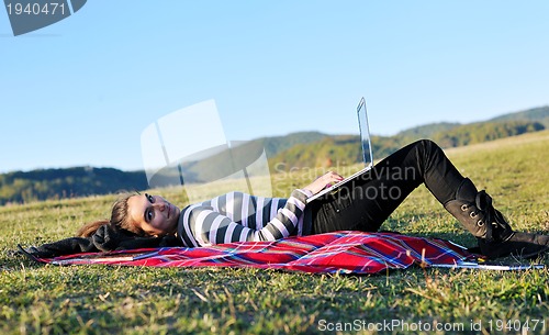 Image of young teen girl work on laptop outdoor