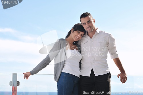 Image of couple relaxing on balcony