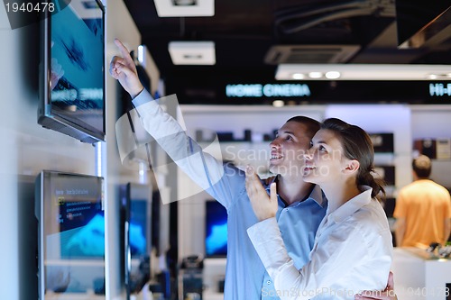 Image of Young couple in consumer electronics store