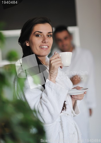 Image of Young love couple taking fresh morning cup of coffee