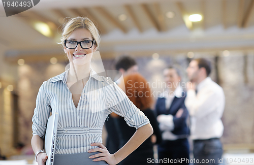 Image of business woman standing with her staff at conference