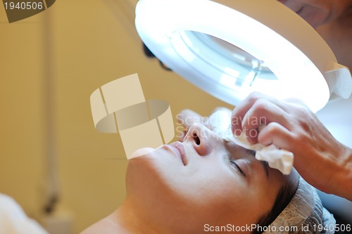 Image of woman with facial mask in cosmetic studio