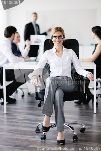 Image of business woman with her staff in background