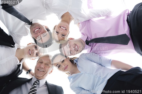 Image of business people with their heads together