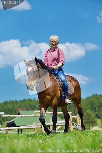 Image of happy woman  on  horse