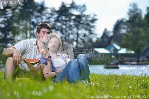 Image of happy young couple having a picnic outdoor