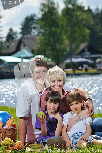 Image of Happy family playing together in a picnic outdoors