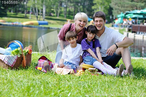 Image of Happy family playing together in a picnic outdoors