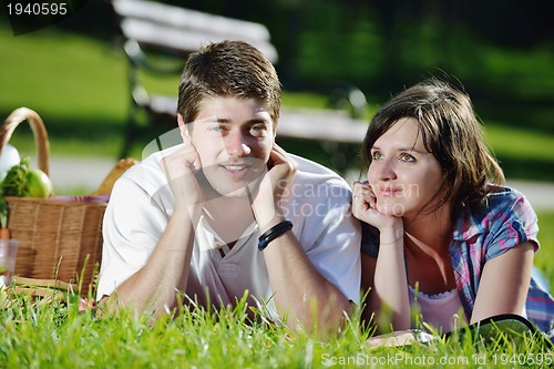 Image of happy young couple having a picnic outdoor