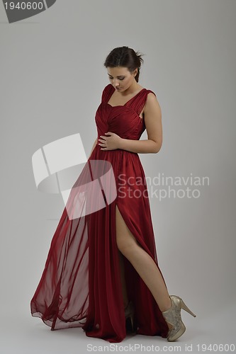 Image of elegant woman in fashionable dress posing in the studio