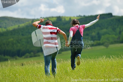 Image of Portrait of romantic young couple smiling together outdoor