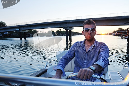 Image of portrait of happy young man on boat