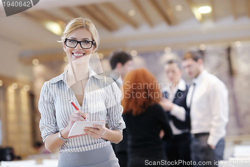 Image of business woman standing with her staff at conference