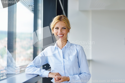 Image of Young pretty business woman with notebook in the office