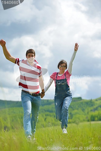 Image of Portrait of romantic young couple smiling together outdoor
