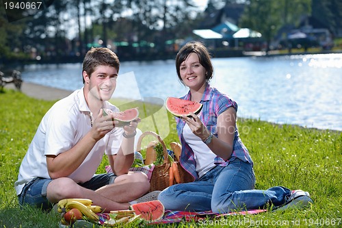 Image of happy young couple having a picnic outdoor