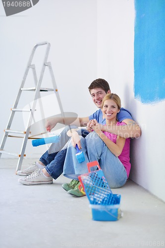 Image of happy young cople relaxing after painting in new home