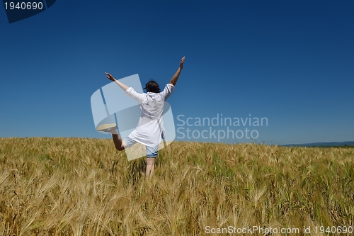 Image of young woman in wheat field at summer