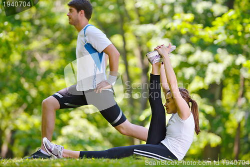 Image of Couple doing stretching exercise  after jogging