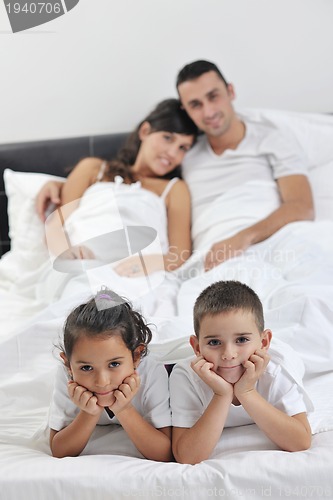 Image of happy young Family in their bedroom