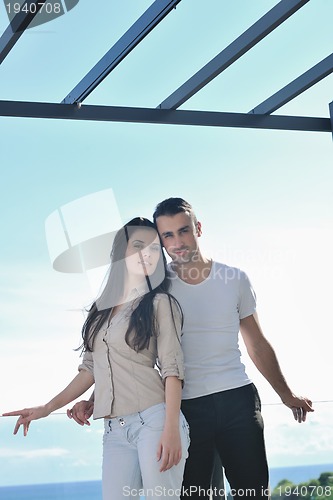 Image of couple relaxing on balcony