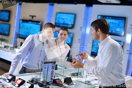 Image of Young couple in consumer electronics store