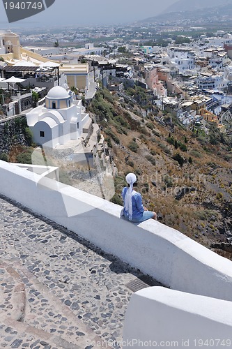 Image of Greek woman on the streets of Oia, Santorini, Greece