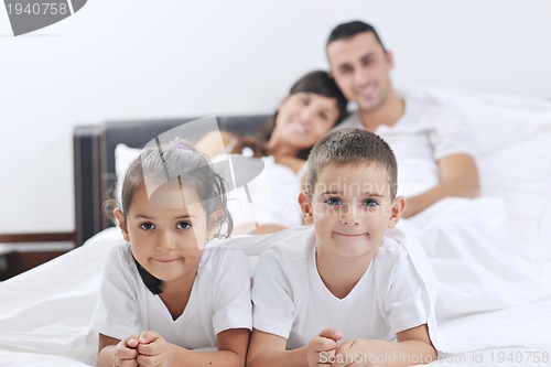 Image of happy young Family in their bedroom