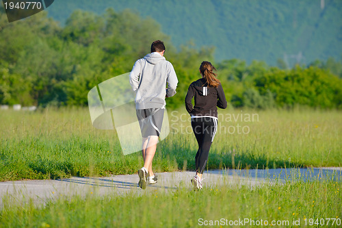 Image of Young couple jogging