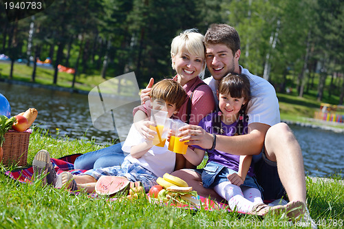 Image of Happy family playing together in a picnic outdoors