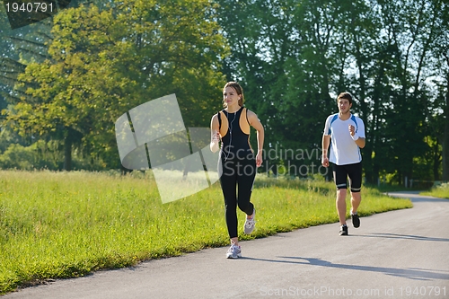 Image of Young couple jogging at morning