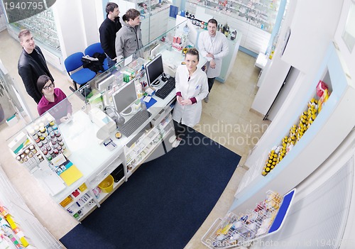 Image of pharmacist suggesting medical drug to buyer in pharmacy drugstor