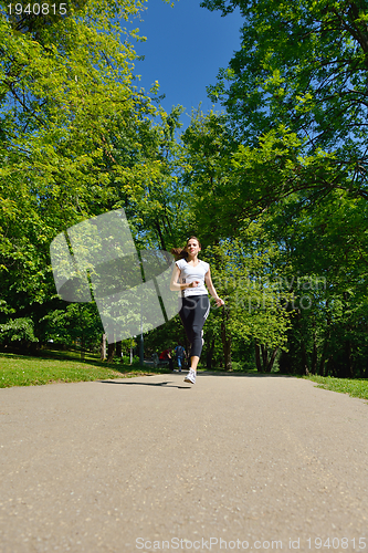 Image of Young beautiful  woman jogging