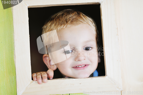 Image of happy child in a window