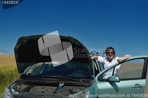 Image of woman with broken car