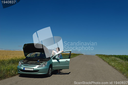 Image of woman with broken car