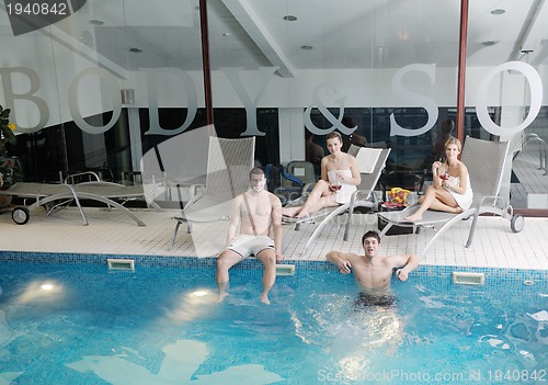 Image of young people group at spa swimming pool