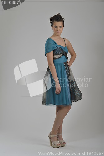 Image of elegant woman in fashionable dress posing in the studio