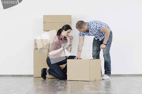 Image of Young couple moving in new home