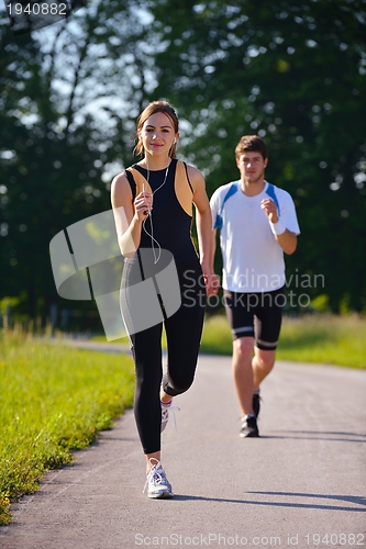 Image of Young couple jogging