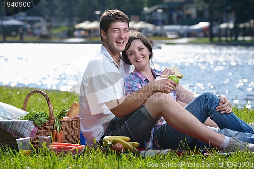 Image of happy young couple having a picnic outdoor