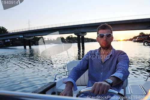 Image of portrait of happy young man on boat
