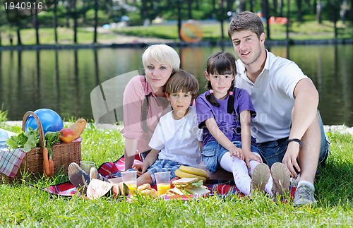 Image of Happy family playing together in a picnic outdoors