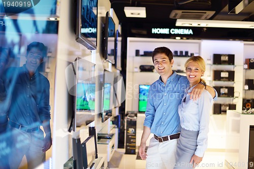 Image of Young couple in consumer electronics store