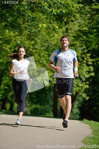 Image of Young couple jogging at morning