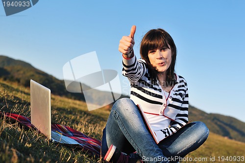 Image of young teen girl work on laptop outdoor