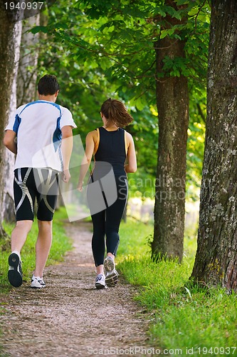 Image of Young couple jogging at morning